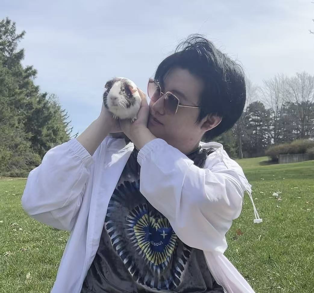 Jiahe outdoors holding a guinea pig